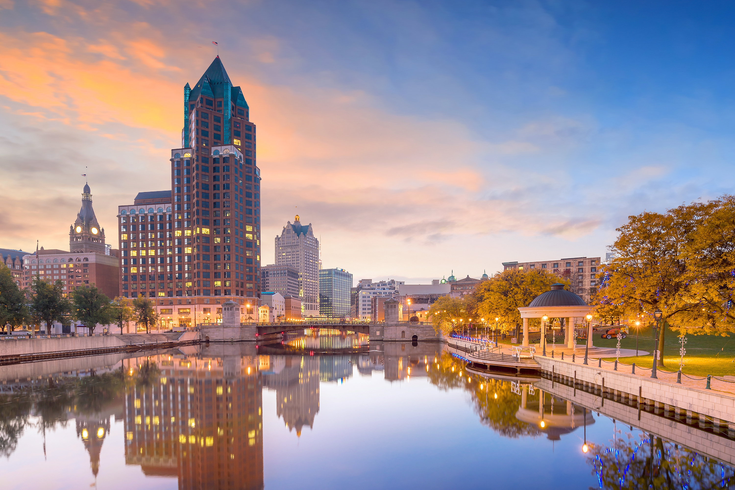 Downtown skyline with Buildings along the Milwaukee River at night, in Milwaukee, Wisconsin.